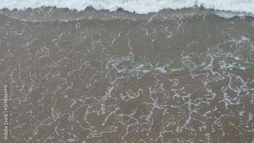 aerial top view drone video clip of scenic wave formation in a sea beach of famous travel destination city Puri in India