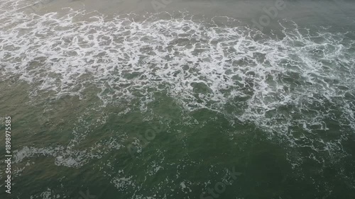 aerial top view drone video clip of scenic wave formation in a sea beach of famous travel destination city Puri in India
