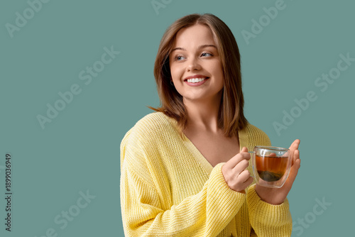 Young woman with glass cup ...