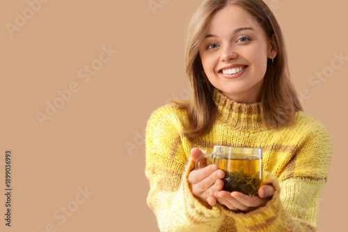 Young woman with glass cup ...