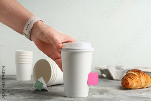 Female hand with paper cups...