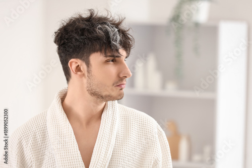 Young man with graying hair...
