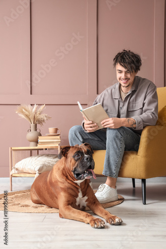 Young man in armchair with ...