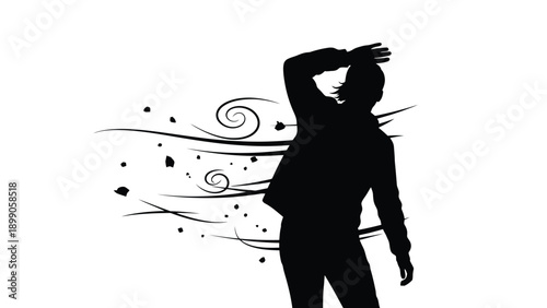 Silhouette of a person struggling against strong winds and flying debris demonstrating an outdoor natural element challenge