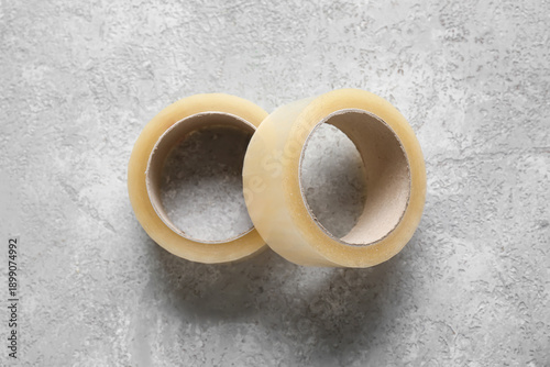 Adhesive tape rolls on grey...