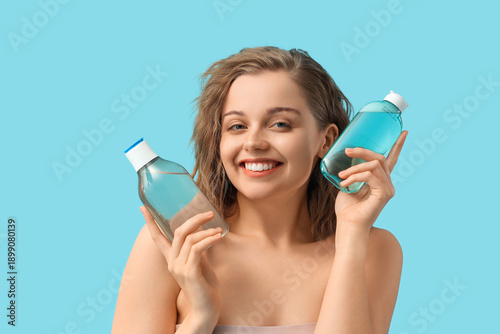 Young woman with bottles of...
