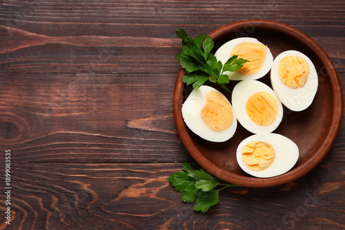 Plate with boiled eggs on wooden background, closeup