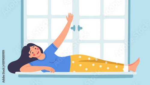 Young woman lying on window sill and waving with a smile indoors  