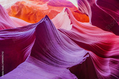 The image is of a canyon with a purple hue
