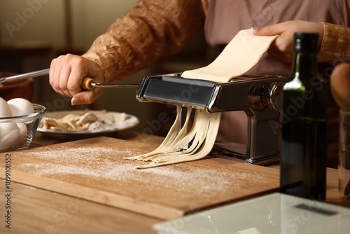 Young woman making pasta wi...