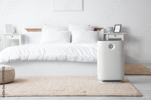 Modern air purifier on carp...