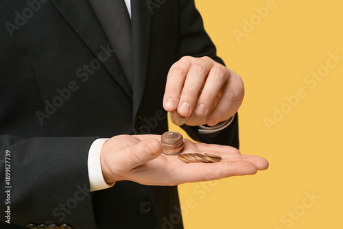 Businessman with coins on y...