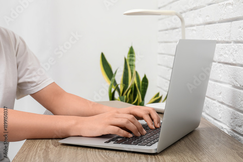Person typing on laptop at ...