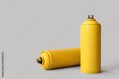 Spray paint cans on white b...