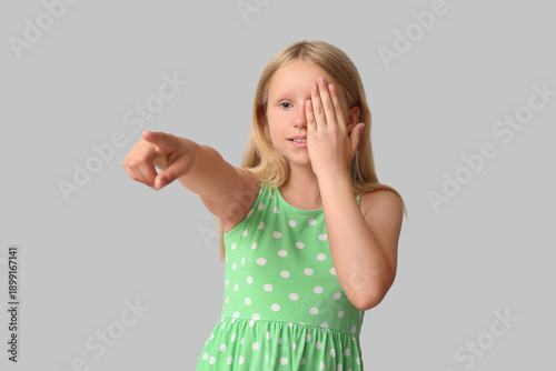 Teenage girl checking her eyesight on light background. Children's Eye Health...