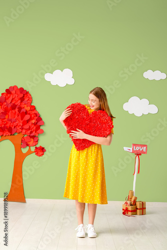 Young woman with heart near...