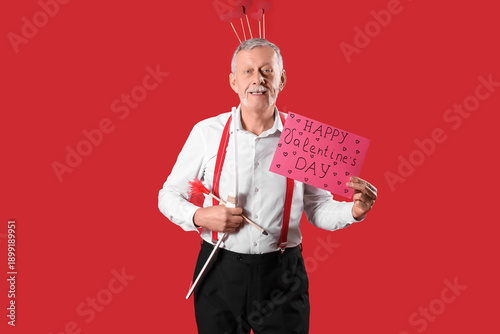 Mature man dressed as Cupid...