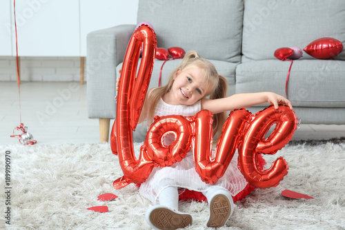 Cute little girl with air balloon in shape of word LOVE in room decorated for Valentines Day