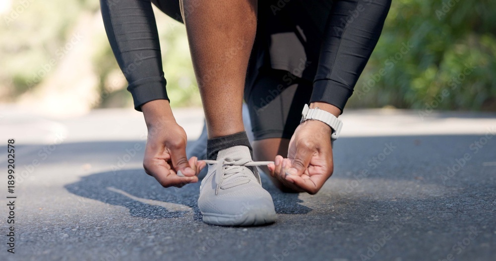 Fototapeta premium Hands, person and tying laces for fitness preparation, start exercise and cardio workout. Athlete, footwear and road for getting ready, endurance training and runner safety for challenge outdoor