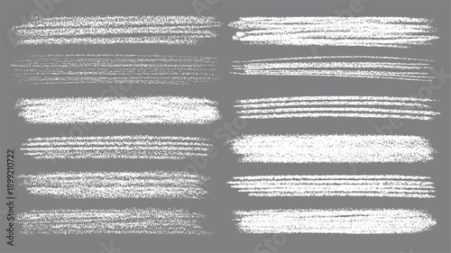 Collection of twelve white chalk brush stroke textures on a grey background