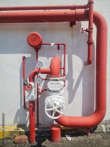 Photos Red fire sprinkler alarm valve and industrial piping system