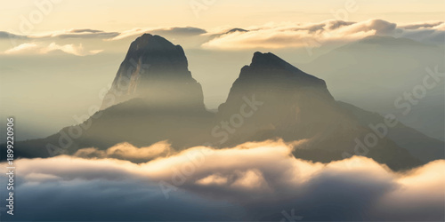 A breathtaking nature landscape features an orange sun rising over misty mountain peaks and hills, casting golden sunlight across the clouds and snow-capped valley at dawn