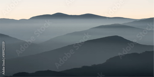 A serene morning mist blankets the blue mountain range at sunrise, creating a foggy landscape where silhouettes of hills and a distant forest emerge from the hazy valley under a glowing sky