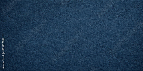 A dark blue denim fabric texture with a rough cotton material pattern creates a grungy textile surface ideal for a fashion background or clothing design wallpaper