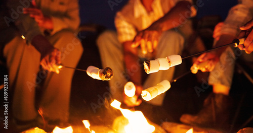 Bild auf Leinwand Night, campfire and hands with marshmallow for cooking, holiday travel and outdoor activity for bonding