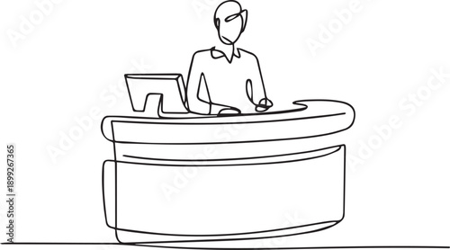 A person working at a reception desk with a computer, viewed from the side in a modern office environment with clean lines.