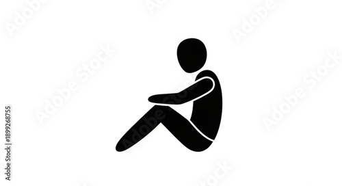 Silhouette of a person sitting with knees pulled to chest.