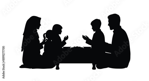 Family gathered around a table in stark black silhouette