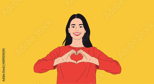Cheerful young woman with long dark hair making a heart shape with her hands in front of her chest on a yellow background.
