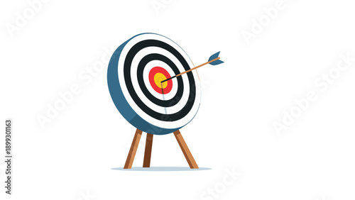 Archery target board standing on a wooden tripod with an arrow hit close to the center, symbolizing focus, goals, and training progress.