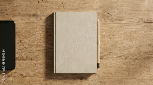 Notebook and pencil on wooden table with digital tablet overhead view