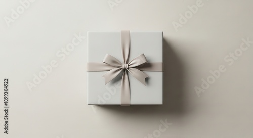 Top View White Gift Box with Silver Ribbon on Neutral Surface
