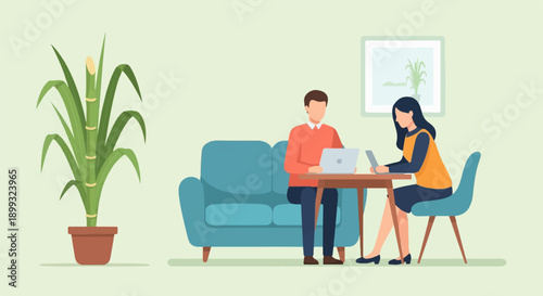 Two people working on laptops at a table with a plant and couch