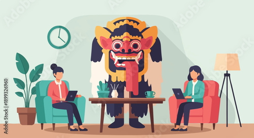 Two people working on laptops in a room with a large, stylized monster mask