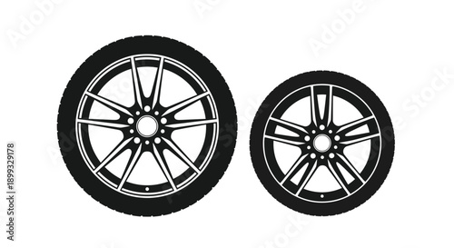 Two car wheels in black contrasting sizes and designs silhouette