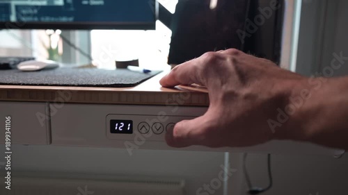 Wallpaper Mural Person adjusting height on an electric standing desk Torontodigital.ca