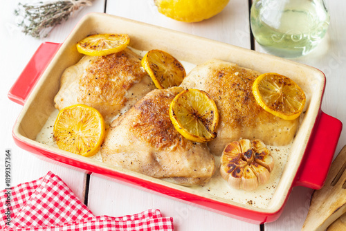 Baked chicken thighs with lemon in a creamy sauce. Recipe.