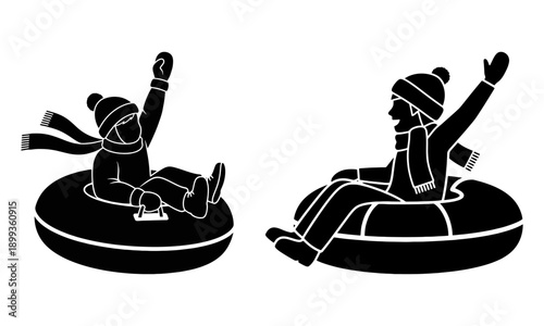 Two children joyfully sledding on inner tubes in a winter scene