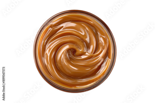 Caramel sauce swirls in a clear glass bowl