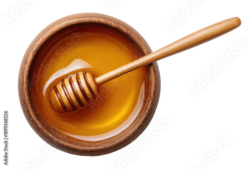 Overhead view of honey in wooden bowl with dipper