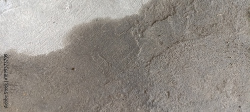 Dark Wet Concrete Floor Texture with Water Stain Pattern. Concrete floor with dark wet stains forming organic shapes, ideal for moody abstract backgrounds