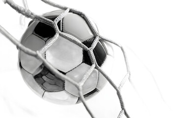 Closeup of a soccer ball hitting the back of a net isolated on transparent background with dramatic lighting effects