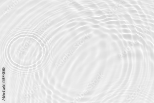 White water with ripples on the surface. Defocus blurred transparent white colored clear calm water surface texture with splashes and bubbles. Water waves with shining pattern texture background.