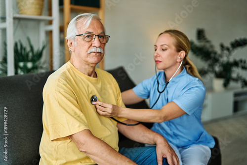 Wallpaper Mural Doctor or nurse caregiver with senior man at home or nursing home Torontodigital.ca