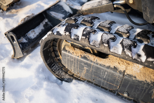 Konstfotografi Winter close up of tracked construction machine showing rubber crawler track wit