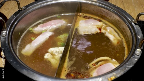 Close up of boiling Shabu Shabu with beef and mushrooms.